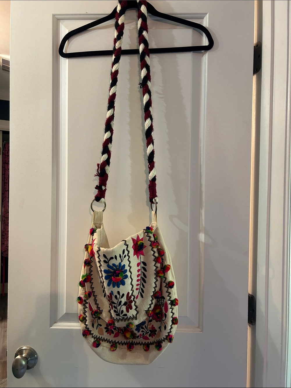 Embroidered Cream Crossbody Bag with Multicolor Floral Accents and Pom poms